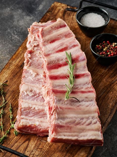 Premium Photo | Raw pork ribs with spices salt pepper and rosemary