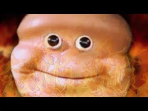 an image of a smiling face with eyes on fire and flames in the back ground