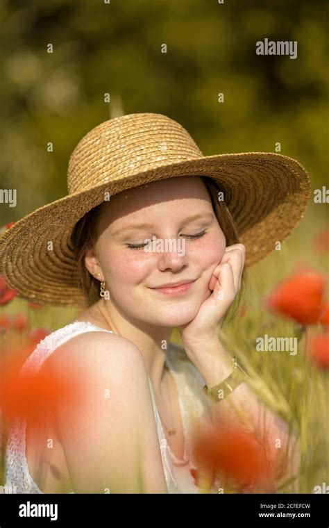 Woman in a straw hat with flowers hi-res stock photography and images ...