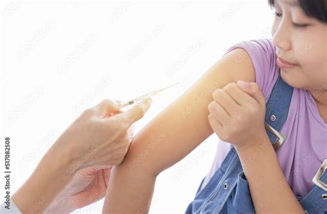 light  blur people doctor inject vaccine  asian girl deltoid