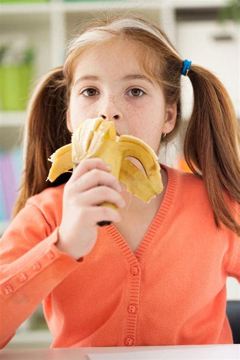 Little Girl Eating Banana