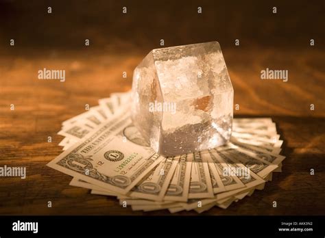 Money on ice cube Stock Photo - Alamy