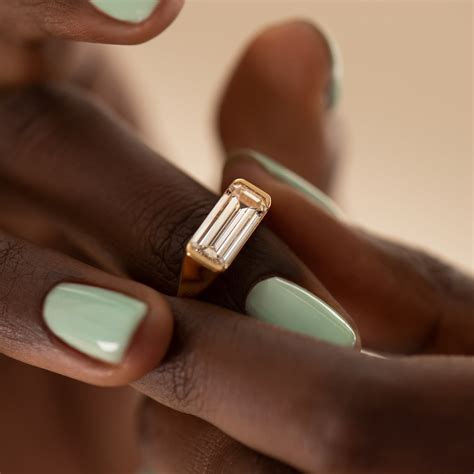 solitaire signet engagement ring with an emerald cut diamond 7