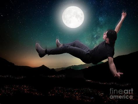 Young man falling in the sky above city in moonlight Photograph by ...