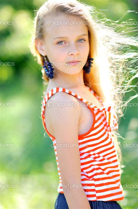 Portrait of little girl outdoors in summer — Stock Photo © zagorodnaya
