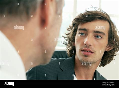Businessmen talking in office Stock Photo - Alamy
