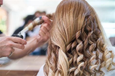 Premium Photo | Woman hairdresser making hairstyle in beauty salon