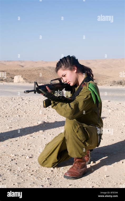 Israeli young female soldier in uniform aiming her M16 rifle Stock ...