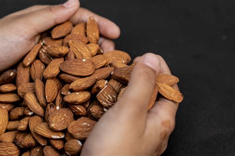 Biji Almond Di Tangan Dengan Latar Belakang Hitam Sebenarnya Adalah ...