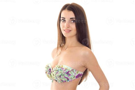 beautiful young girl in a bathing suit with big breasts looks into the