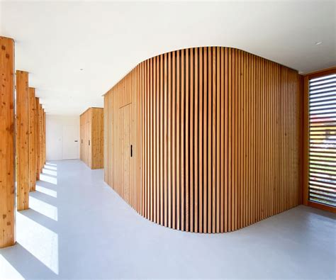 Hidden door frames with wooden lamella cladding - DORSIS realization