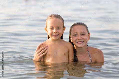 Girls sisters have fun bathing in the sea Stock 写真 | Adobe Stock