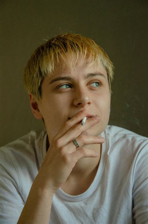 Woman Smoking While Leaning on Wall · Free Stock Photo