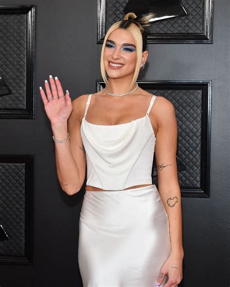 Dua Lipa arrives in slinky Alexander Wang slip inspired dress at the