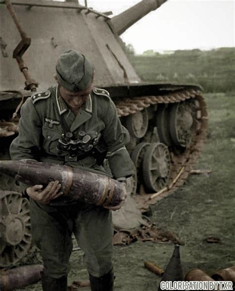 A German feldwebel looking at a 152mm shell taken from the destroyed ...
