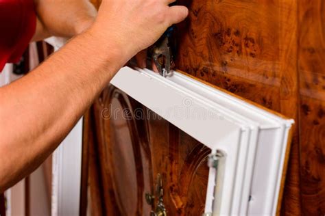 A Worker Installs New Plastic Windows in the House, Drills Holes in the ...