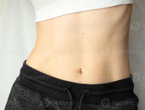 A woman shows her flat stomach. Athletic belly of a young girl 10247751