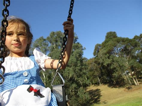 premium photo cute girl swinging  park