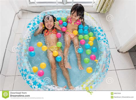 Happy Asian Chinese Little Sisters Playing in the Inflatable Poo Stock ...