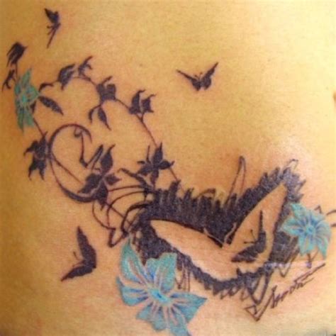 a woman's stomach with tattoos on it and birds flying over her belly,