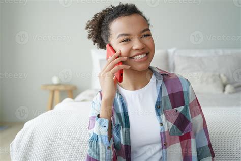 Smiling young african american teen girl making phone call, talking