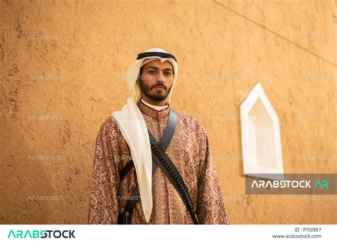 A Saudi Arab Gulf man wearing a traditional costume for national and festive occasions, a ...