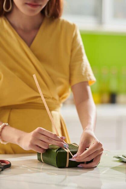 premium photo woman packing square cake