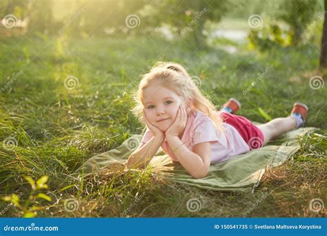 Little Girl is Lying on the Grass Stock Image - Image of colours ...