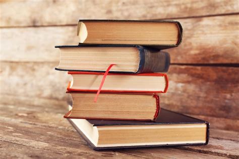 Premium Photo | Pile of books on wooden background