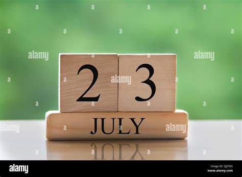 July 23 calendar date text on wooden blocks with blurred background ...
