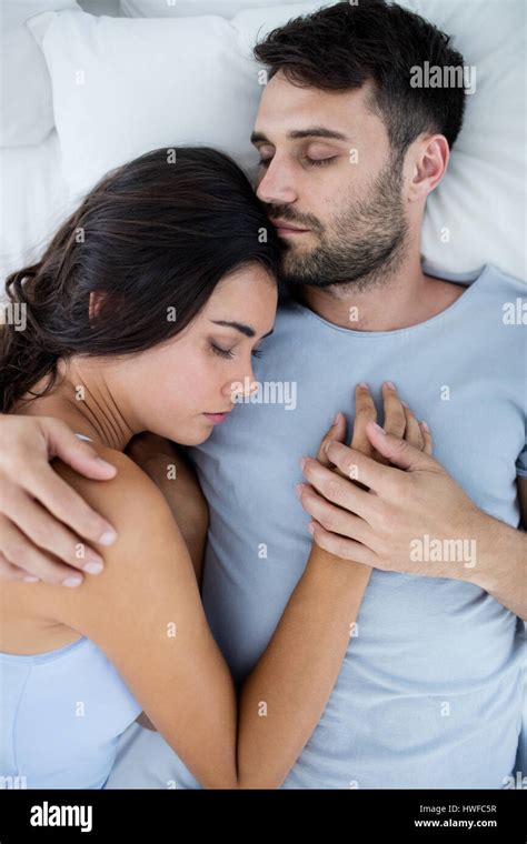 Young romantic couple sleeping on bedÃ‚Â in bedroom Stock Photo - Alamy