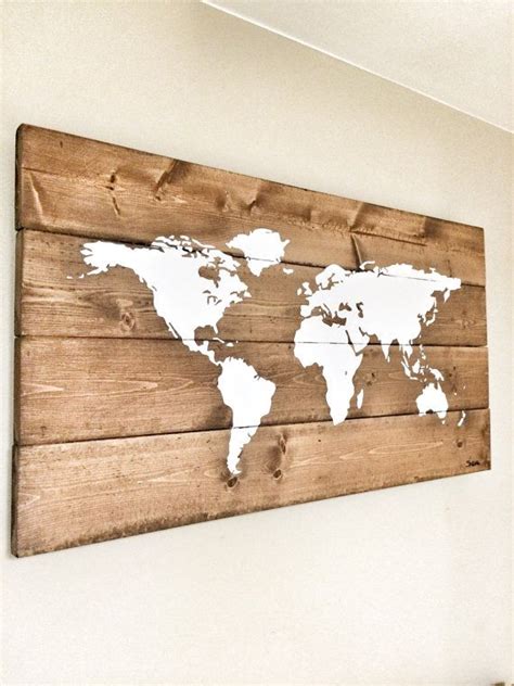 a wooden sign with a world map painted on it's side, hanging on the wall