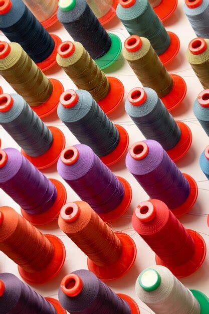 premium photo row  multicolored thread spools  sewing factory