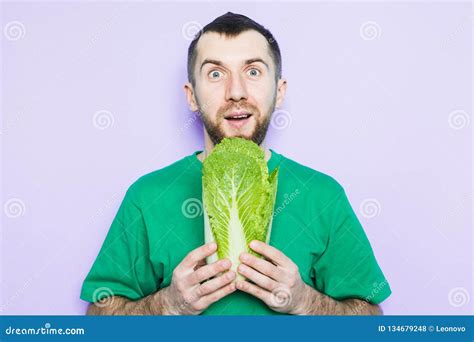 young man holding beijing napa cabbage   hands stock photo image