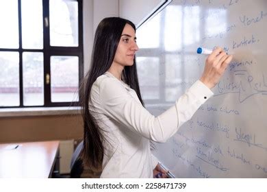 Female Teacher Writing On Whiteboard Stock Photo 2258471739 | Shutterstock