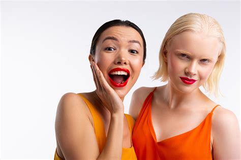 Women With Dark And Blonde Hair Having Bright Red Lips Stock Photo ...
