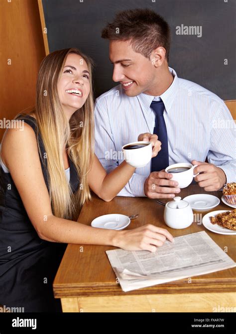 Happy business couple smiling together in a café Stock Photo - Alamy