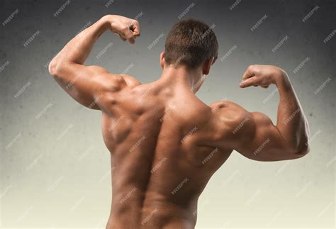 premium photo body builder flexing biceps