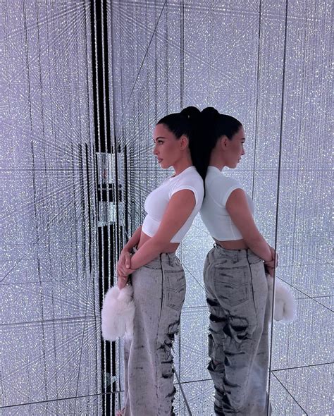 Kim Kardashian shows off her ultra-tiny waist in baggy jeans and white