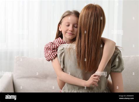 cute daughter hugging mom  res stock photography  images alamy