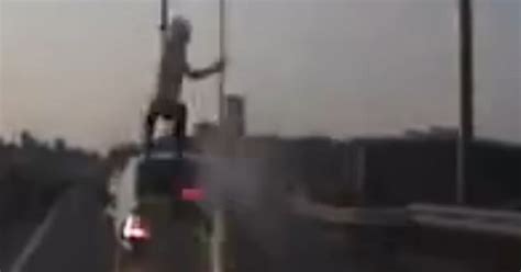 Watch flying biker's incredible acrobatic escape from motorway car ...