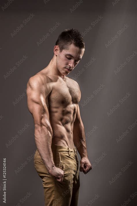 young bodybuilder flexing arm biceps triceps muscle Stock Photo | Adobe Stock