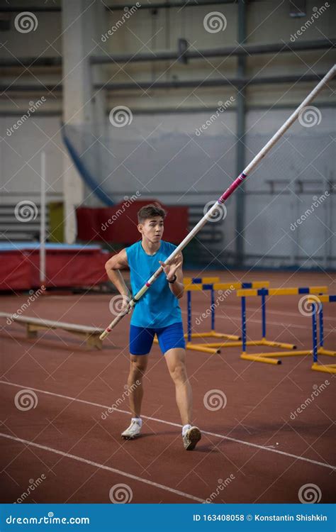 Pole Vaulting Indoors - Young Man Standing on the Runway Holding a Pole ...