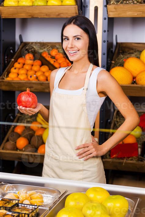 las frutas más frescas de la ciudad. hermosa joven en delantal