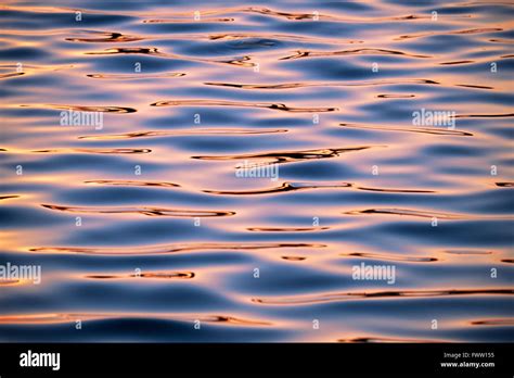 Sunset water ripple reflection background Stock Photo - Alamy
