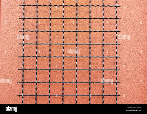 black wire grid   salmon stucco wall stock photo alamy