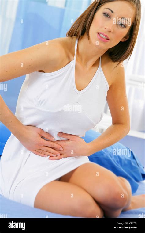 ABDOMINAL PAIN IN A WOMAN Stock Photo - Alamy
