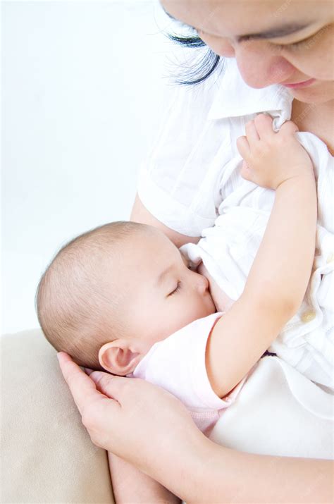 Premium Photo | Asian mother breastfeeding her baby girl