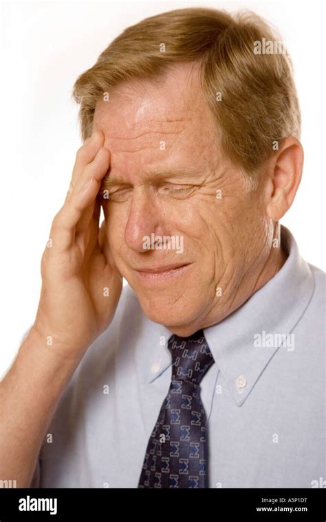 Man experiencing headache. Turn down that music please Stock Photo - Alamy