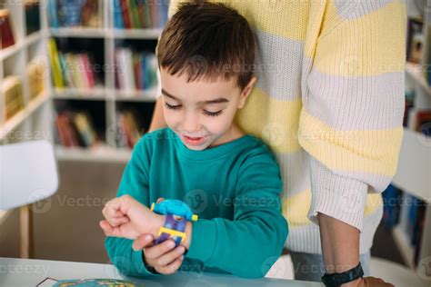 Mom gives her son his first watch. Learning to determine the time by
